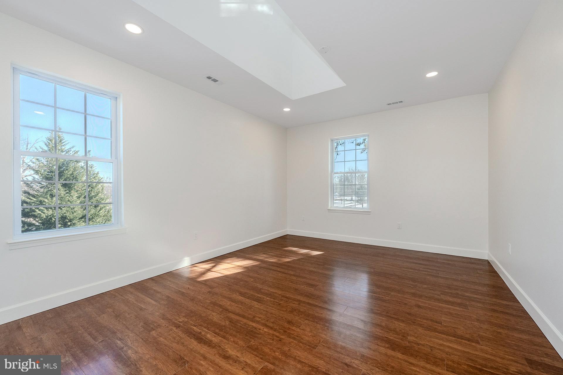 12300 Braddock Road Fairfax, VA 22030 - Photo 49 of 70 an empty room with wooden floor and windows