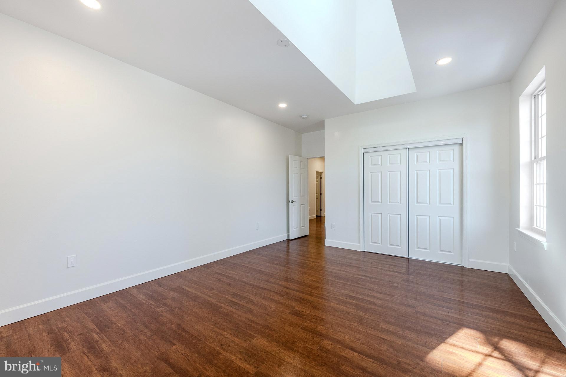12300 Braddock Road Fairfax, VA 22030 - Photo 50 of 70 an empty room with wooden floor and windows