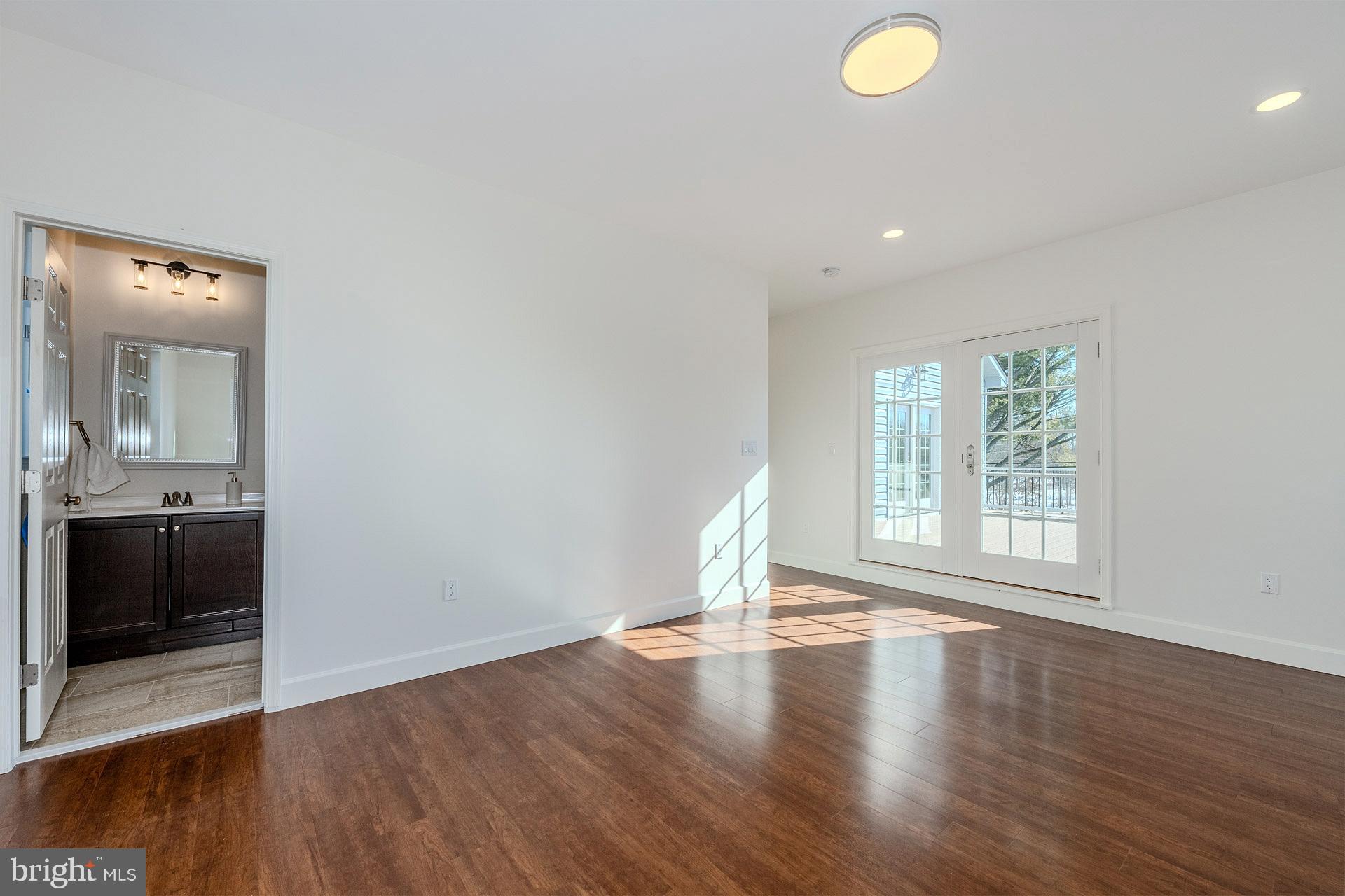 12300 Braddock Road Fairfax, VA 22030 - Photo 56 of 70 an empty room with wooden floor and windows