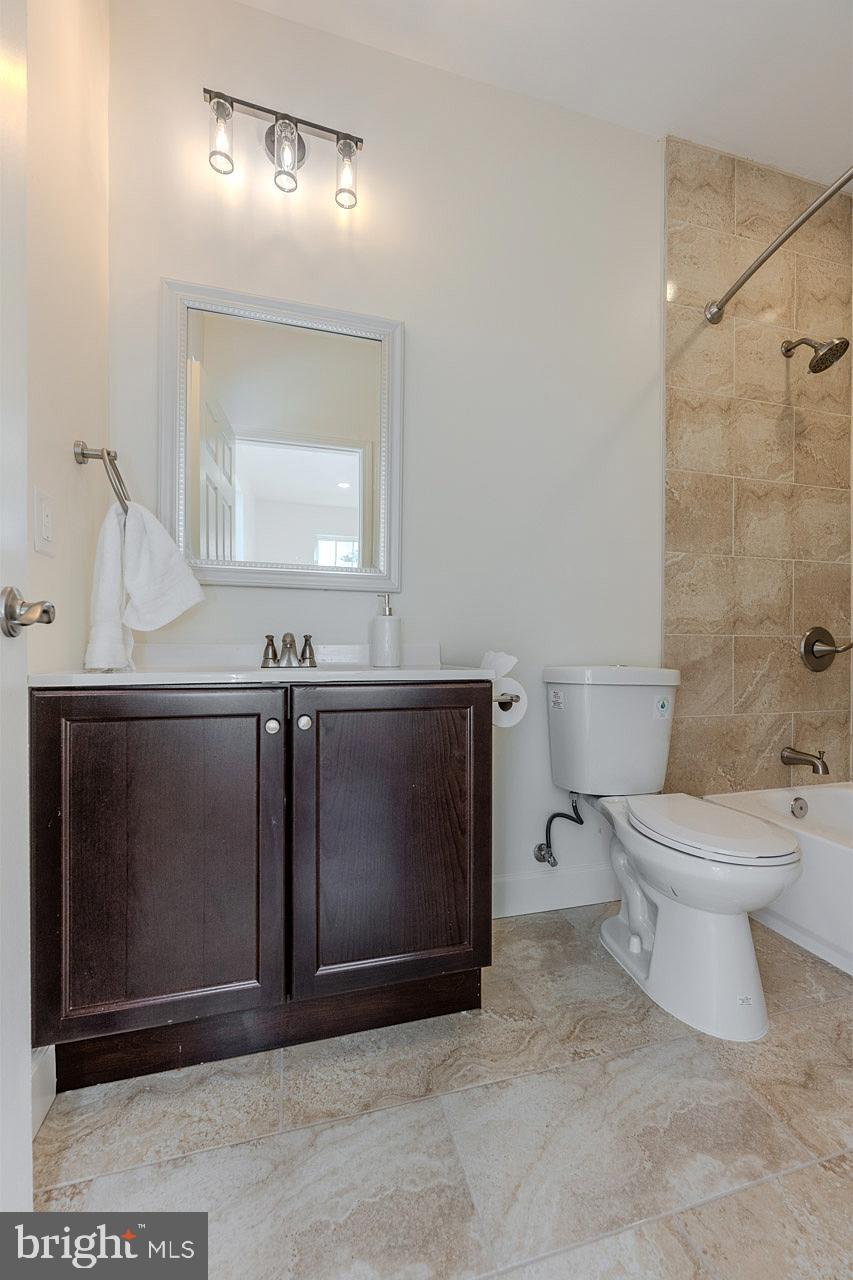 12300 Braddock Road Fairfax, VA 22030 - Photo 57 of 70 a bathroom with a toilet sink and mirror