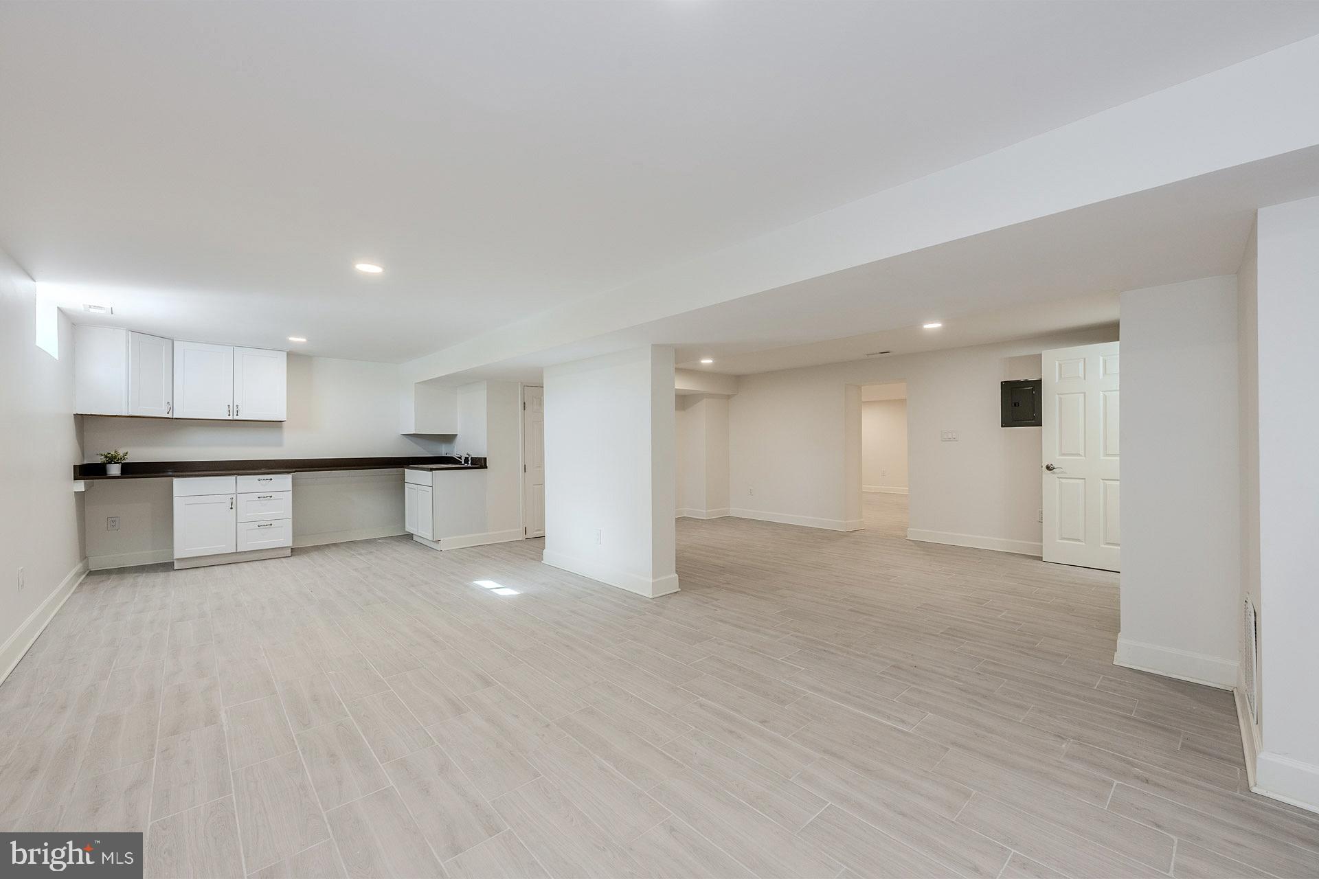 12300 Braddock Road Fairfax, VA 22030 - Photo 59 of 70 a view of an empty room with wooden cabinet kitchen view and a window