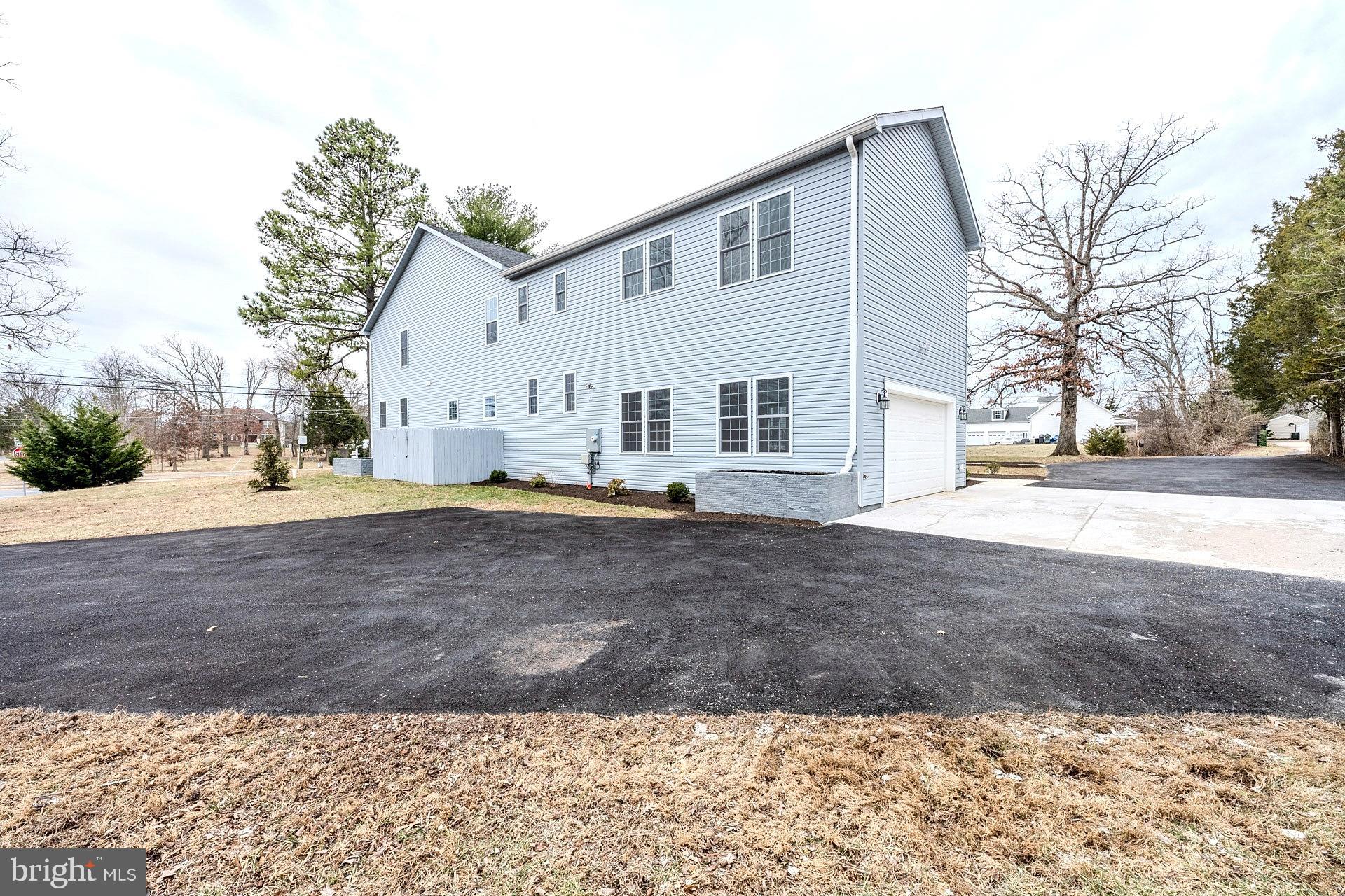 12300 Braddock Road Fairfax, VA 22030 - Photo 70 of 70 a front view of a house with a yard and garage