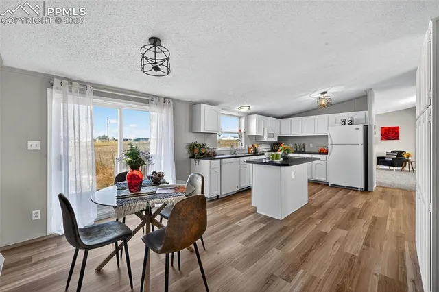 a kitchen with stainless steel appliances a stove refrigerator sink and cabinets