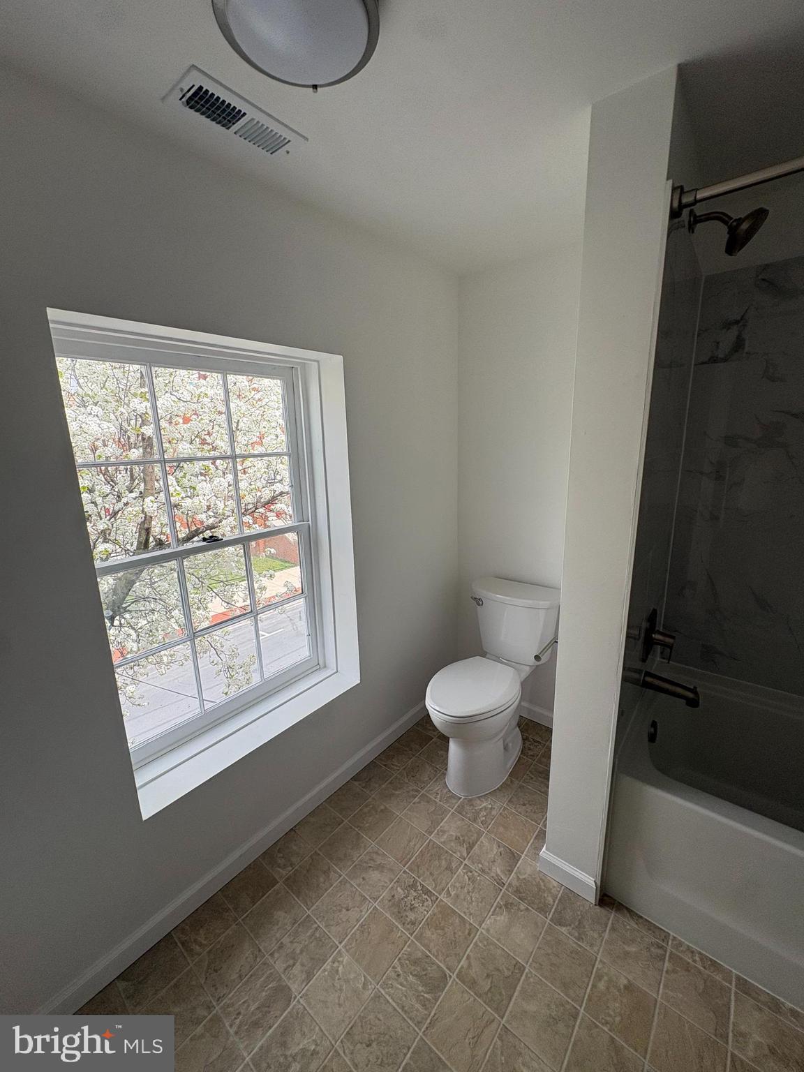 104 West All Saints Street, Unit C2 Frederick, MD 21701 - Photo 17 of 19 a bathroom with a toilet a sink and a window