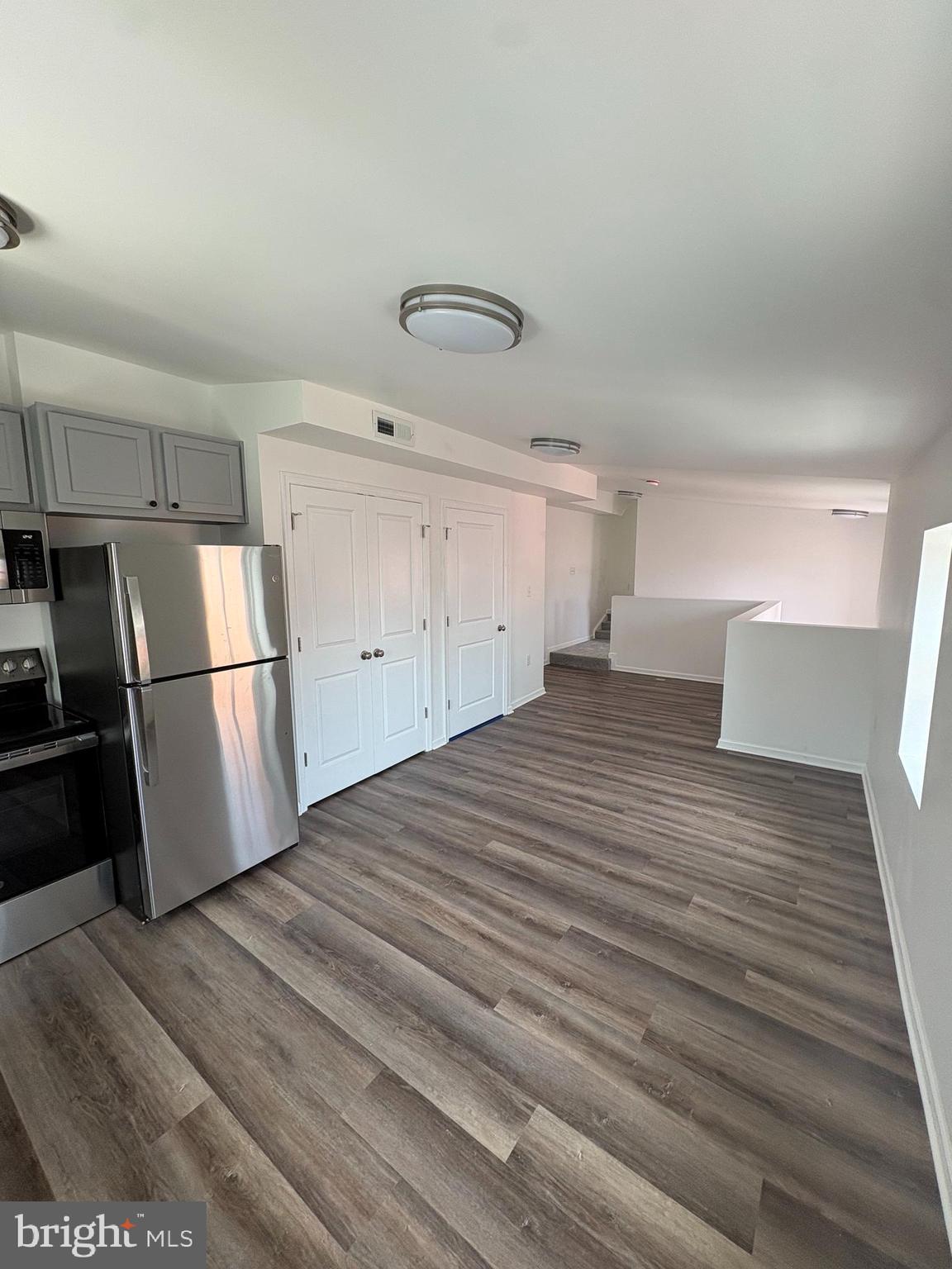 104 West All Saints Street, Unit C2 Frederick, MD 21701 - Photo 10 of 19 a view of a kitchen with wooden floor and electronic appliances