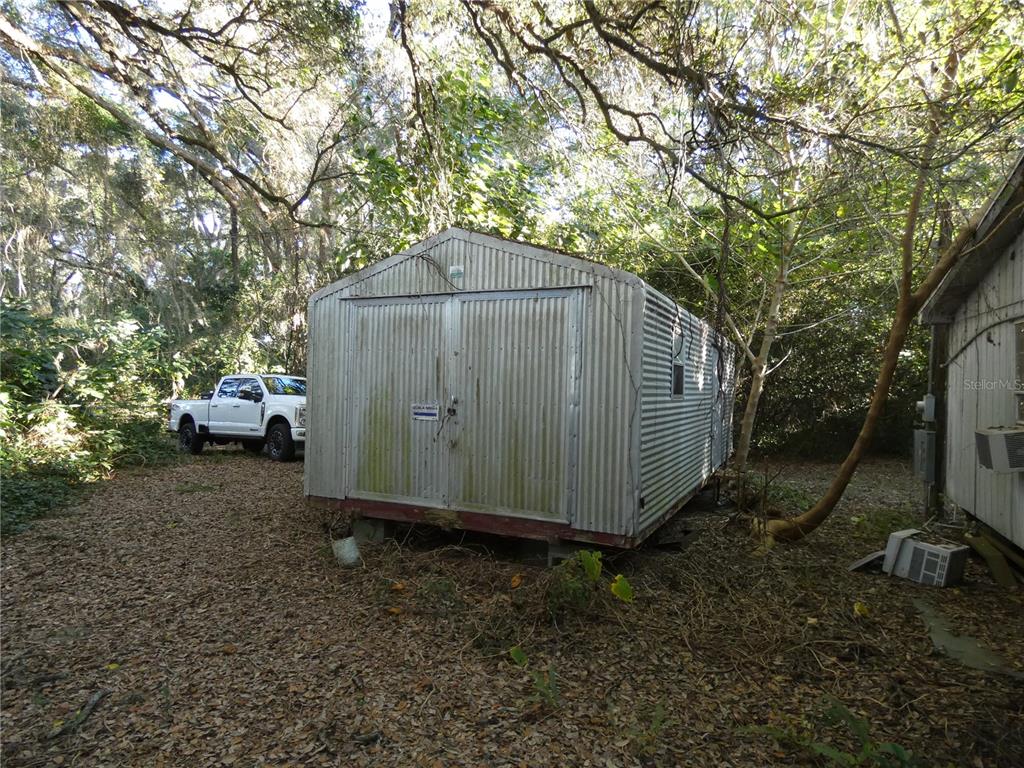 13701 Mockingbird Lane Citra, FL 32113 - Photo 2 of 10 a small barn in the middle of a yard
