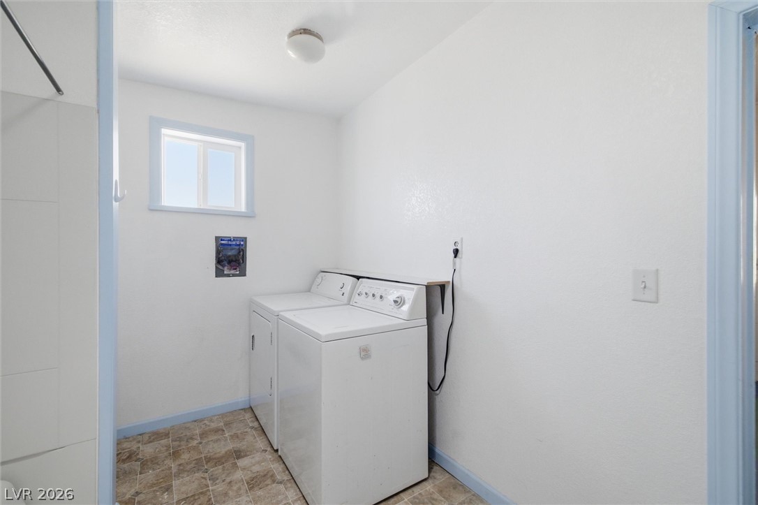 405 Main Street Beatty, NV 89003 - Photo 11 of 28 Functional utility room featuring vinyl flooring and a window for natural light.