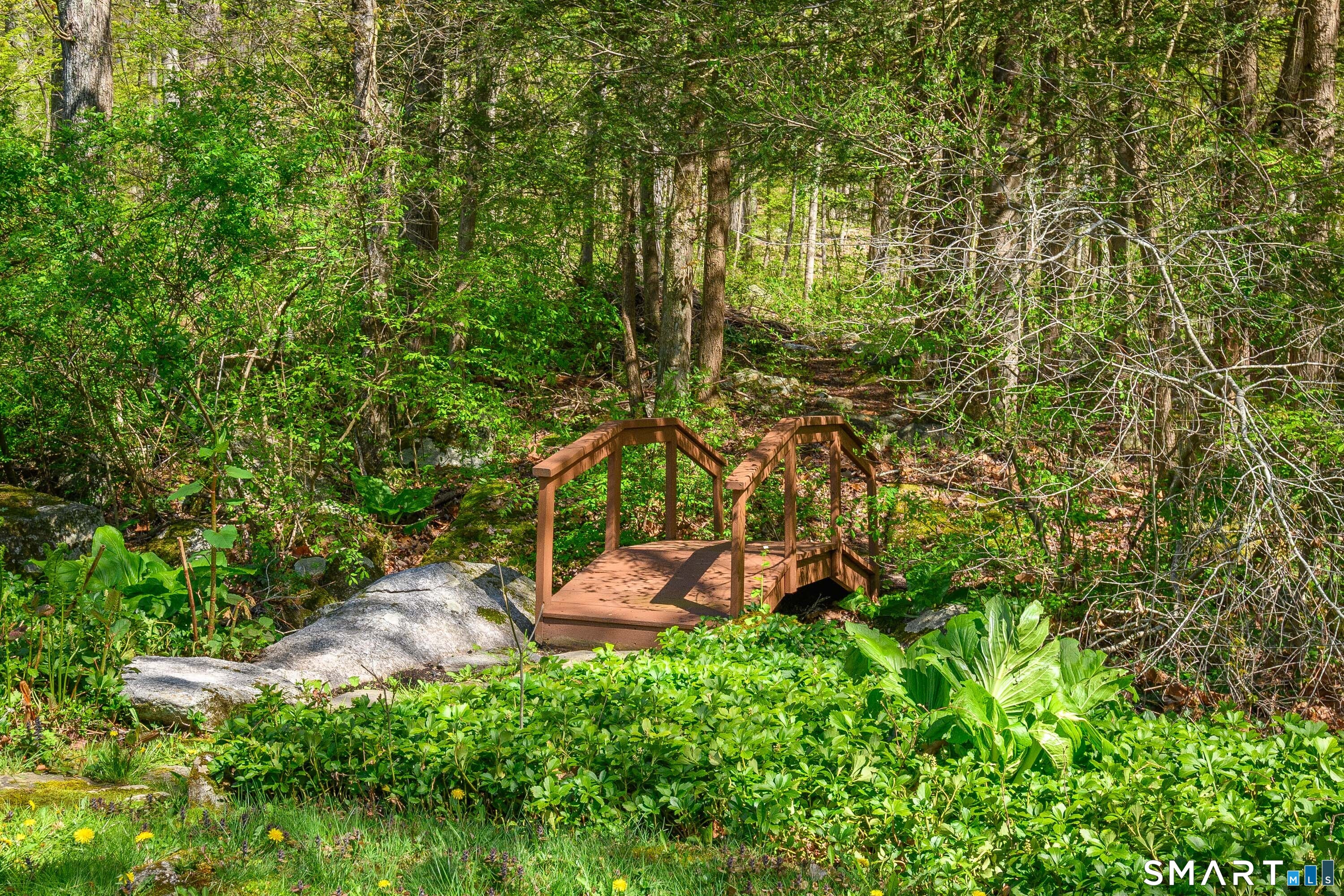 6 High Rock Road Newtown, CT 06482 - Photo 7 of 40 a backyard of a house with outdoor seating and green space