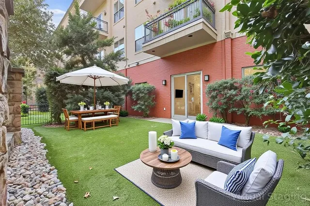 a view of a patio with couches and a table and chairs