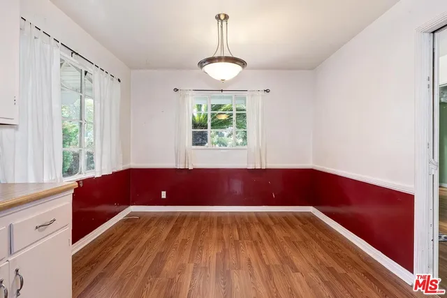 a view of kitchen with wooden floors and large window