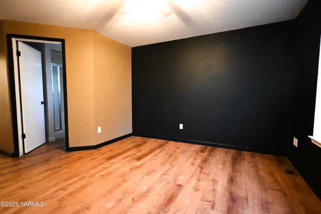 a view of a room with a wooden floor and a window