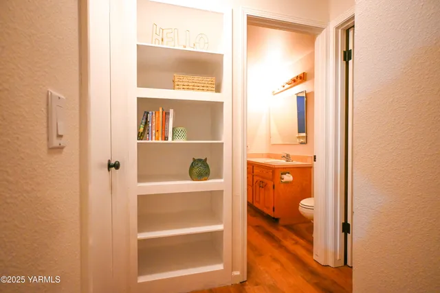 a bathroom with a granite countertop toilet sink and mirror
