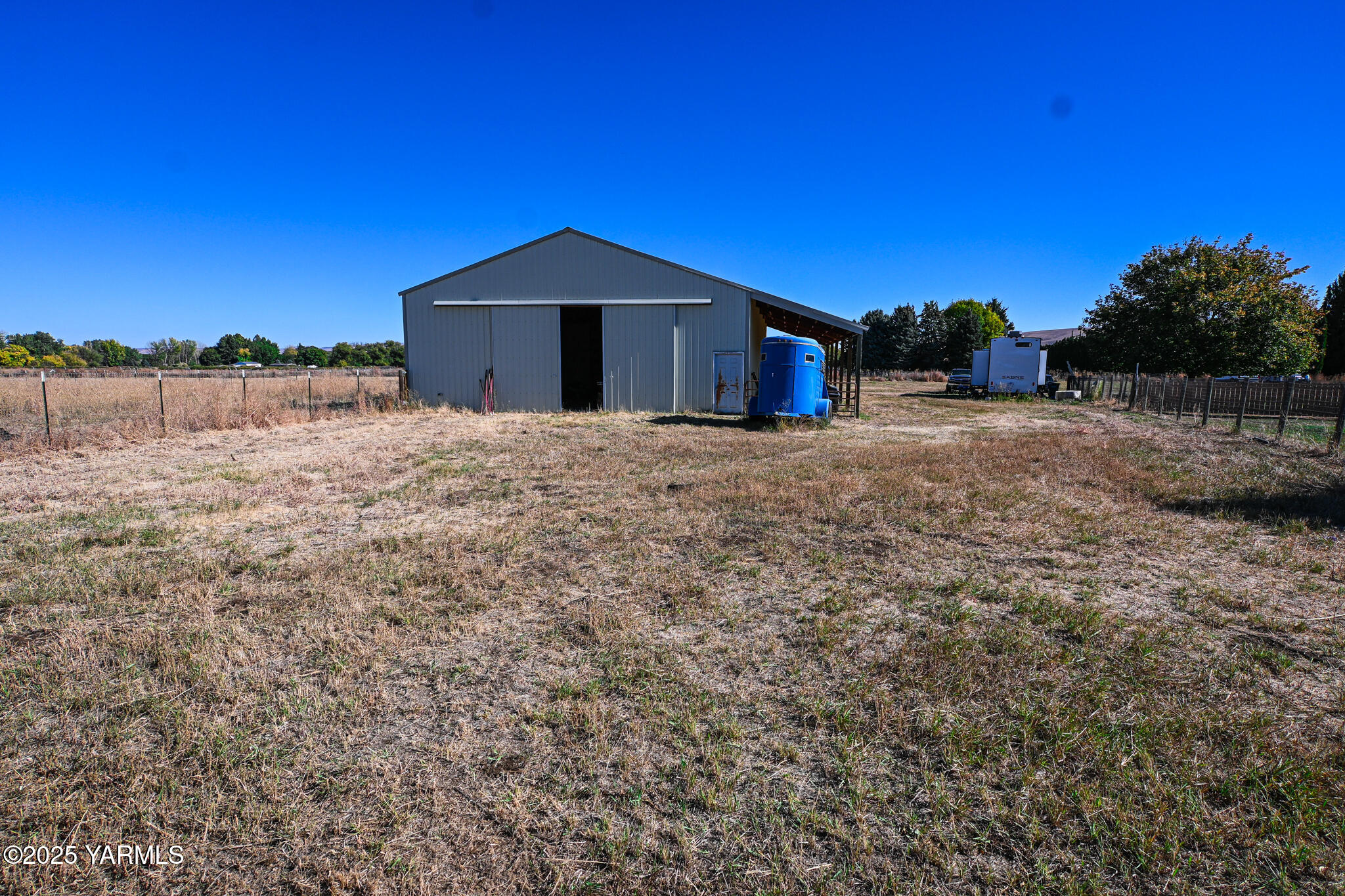 9621 Meadowbrook Road Yakima, WA 98903 - Photo 23 of 41 a house with trees in the background