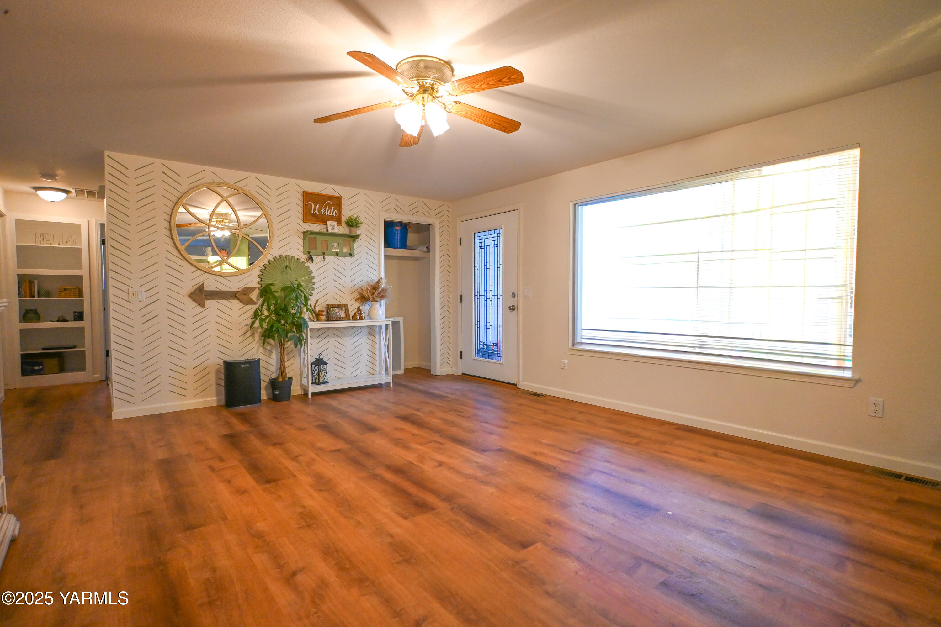 9621 Meadowbrook Road Yakima, WA 98903 - Photo 3 of 41 a view of an empty room with a window and wooden floor