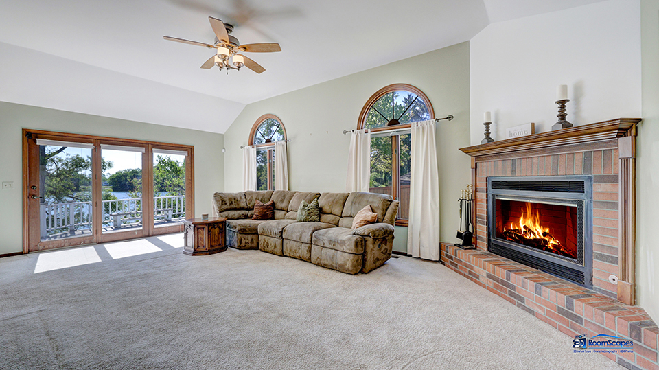 2276 High Point Drive Lindenhurst, IL 60046 - Photo 4 of 15 a living room with furniture a fireplace and a floor to ceiling window
