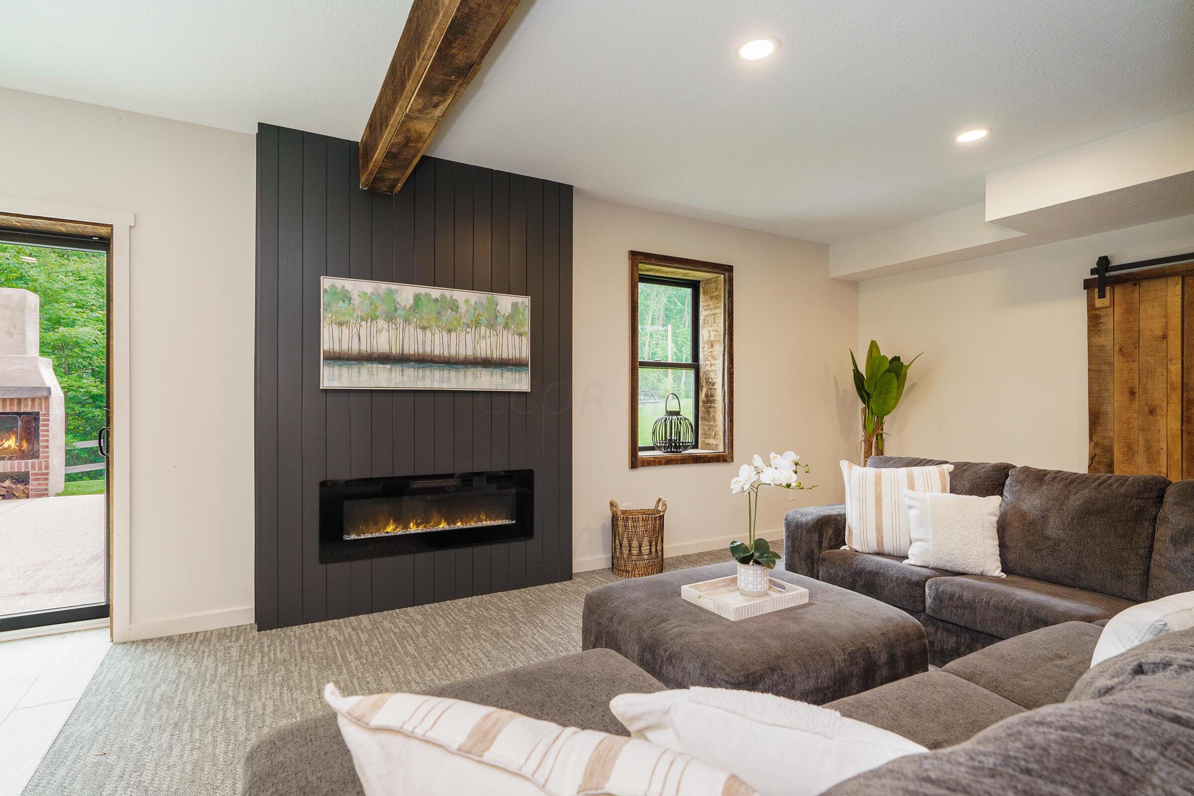 701 Ross Road Sunbury, OH 43074 - Photo 55 of 74 Enjoy the ambiance and convenience of the direct vent fireplace and easy access to the patio, hot tub and swimming pool