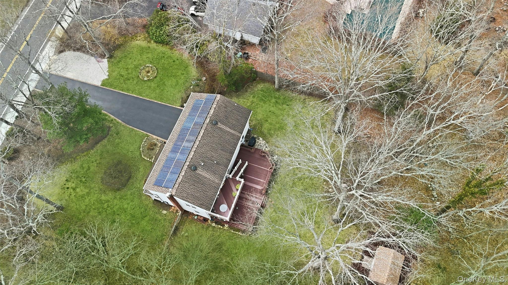 41 North Country Road Shoreham, NY 11786 - Photo 30 of 31 view from above featuring long driveway, roof with solar panels and shed.