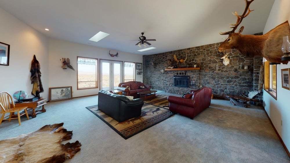 a living room with furniture gym equipment and a fireplace