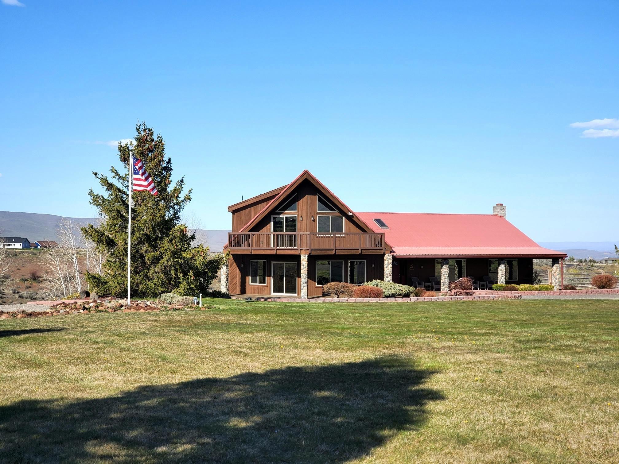 301 Red Tail Road Yakima, WA 98908 - Photo 2 of 52 a front view of a house with swimming pool having outdoor seating