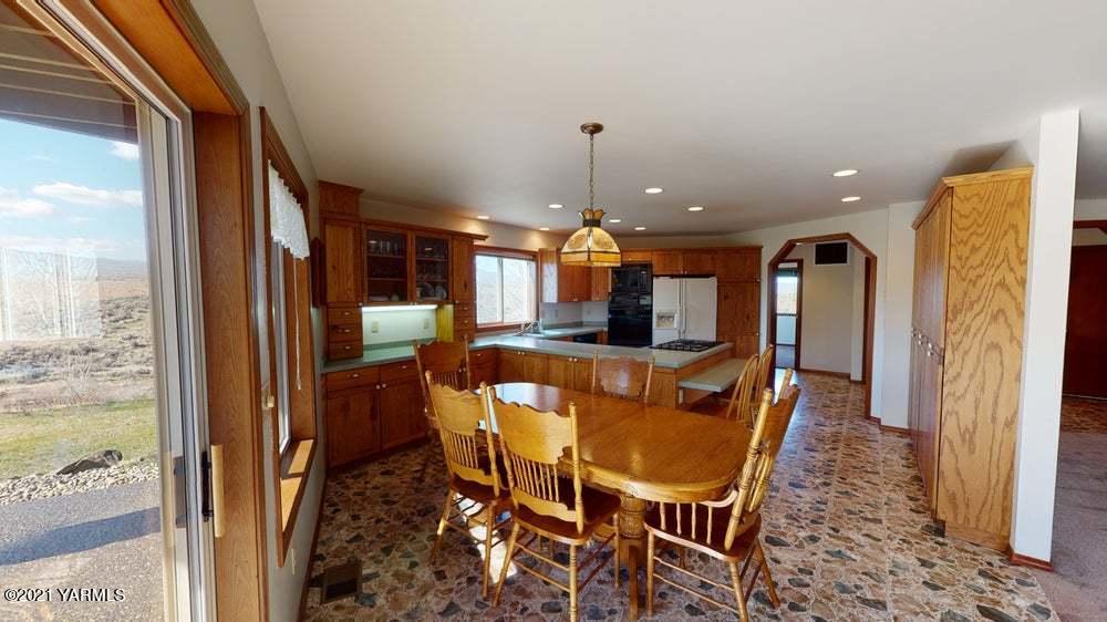 301 Red Tail Road Yakima, WA 98908 - Photo 15 of 52 a dining room with furniture a chandelier and wooden floor