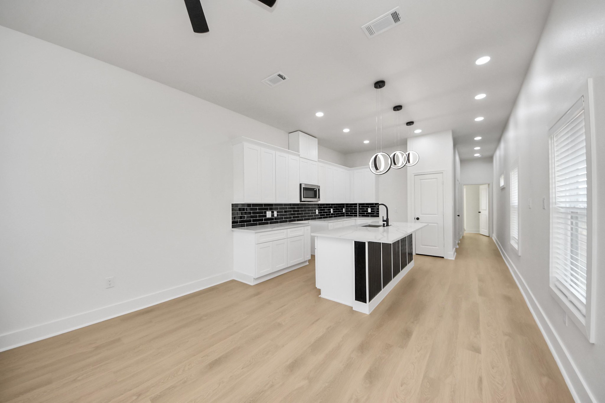 5226 Ricky Street Houston, TX 77033 - Photo 17 of 50 a kitchen with a refrigerator and white cabinets