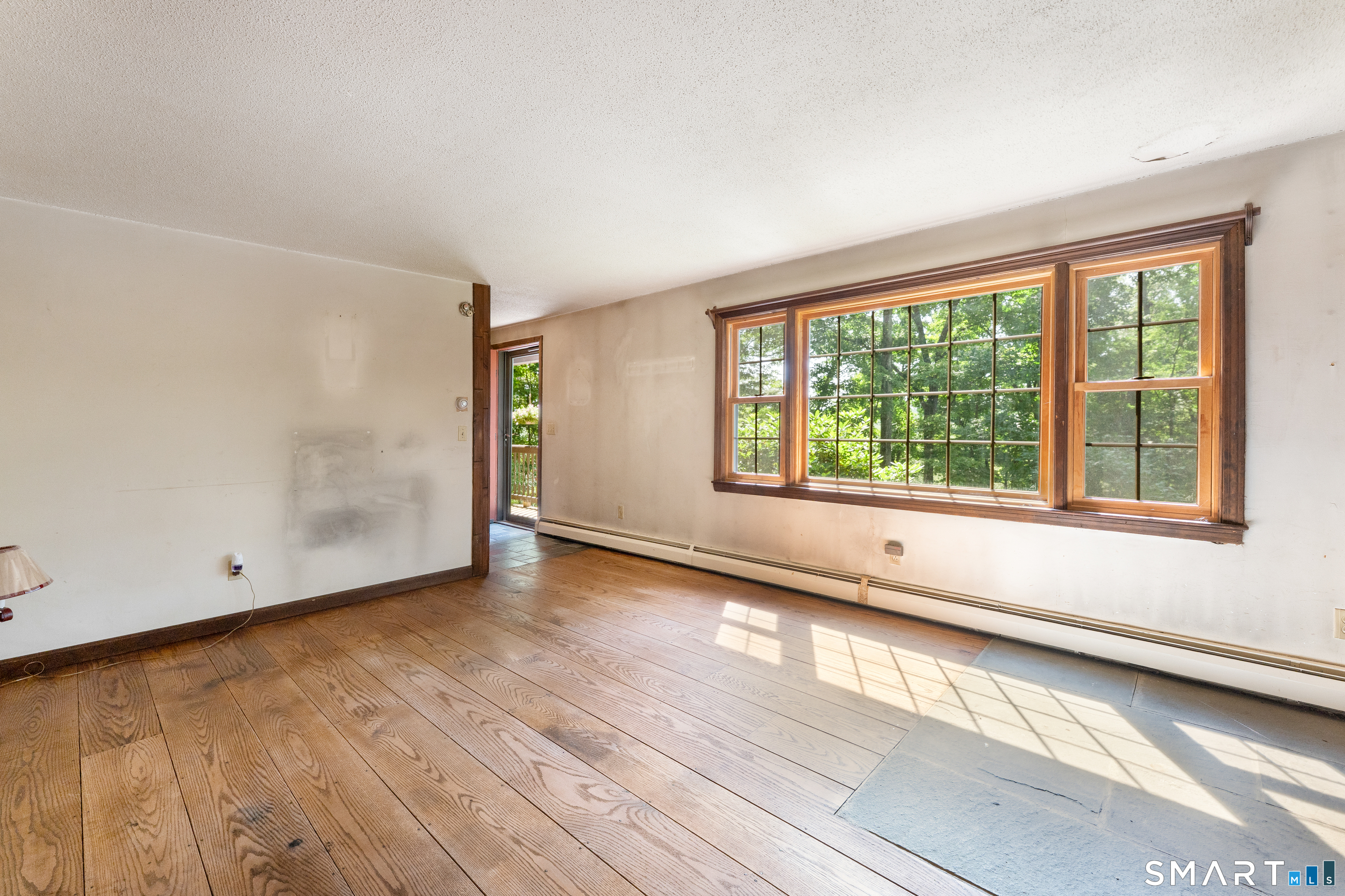 35 Pigeon Swamp Road, Unit 2 Lebanon, CT 06249 - Photo 28 of 35 an empty room with wooden floor and windows