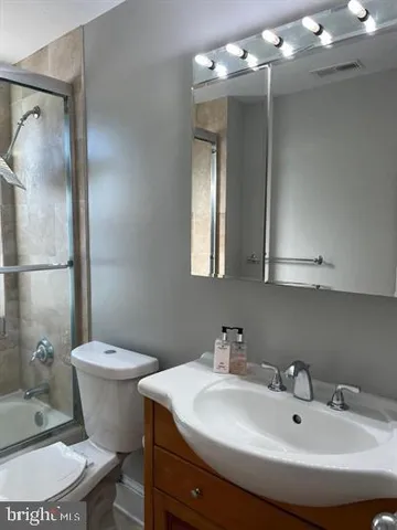 a bathroom with a sink toilet a mirror and shower