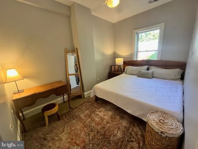 a bedroom with a bed and a window