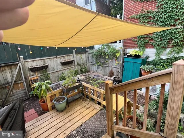 a view of balcony with wooden floor and seating space