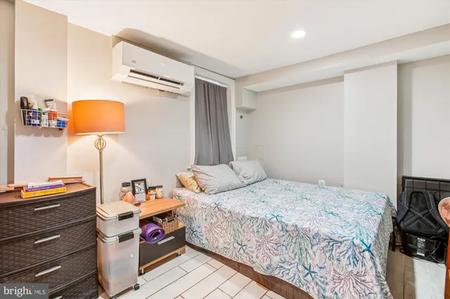 a bedroom with a bed and a washer dryer