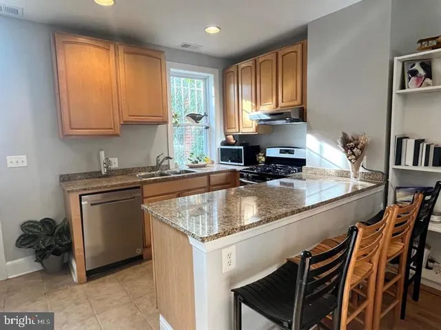 a kitchen with a stove a sink and a microwave