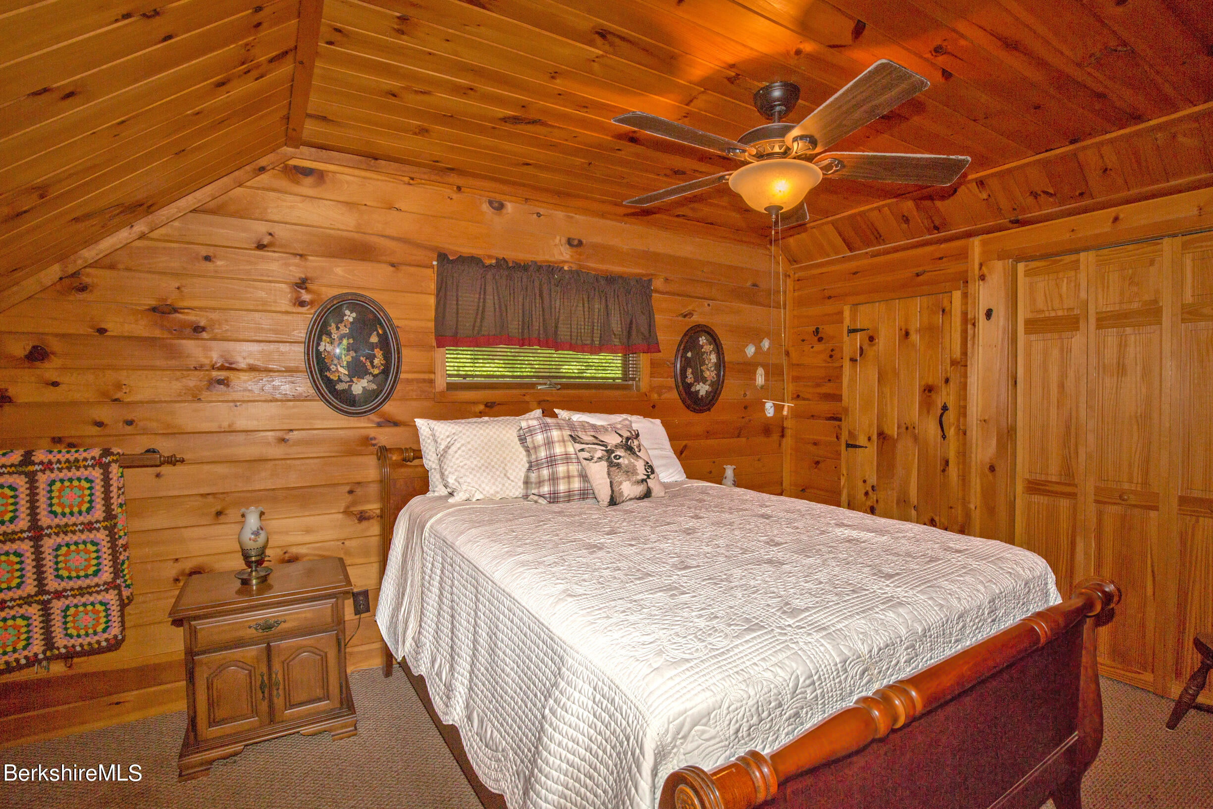 257 West Center Road Otis, MA 01253 - Photo 17 of 44 a bed sitting in a bedroom next to a window and a chair