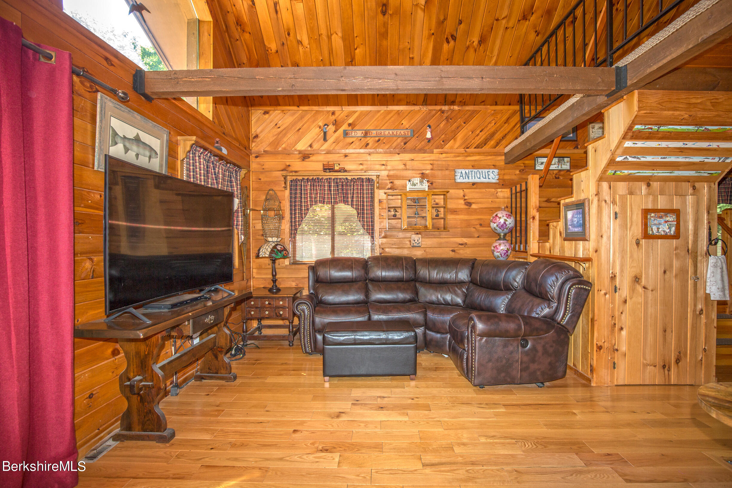 257 West Center Road Otis, MA 01253 - Photo 8 of 44 a living room with couches a flat screen tv and kitchen view