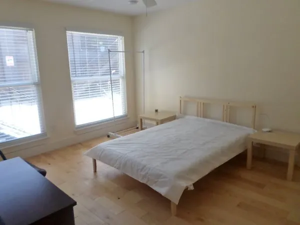 a bed sitting in a bedroom next to a window