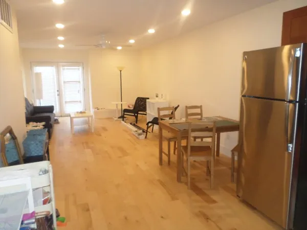 a view of a livingroom with wooden floor and closet