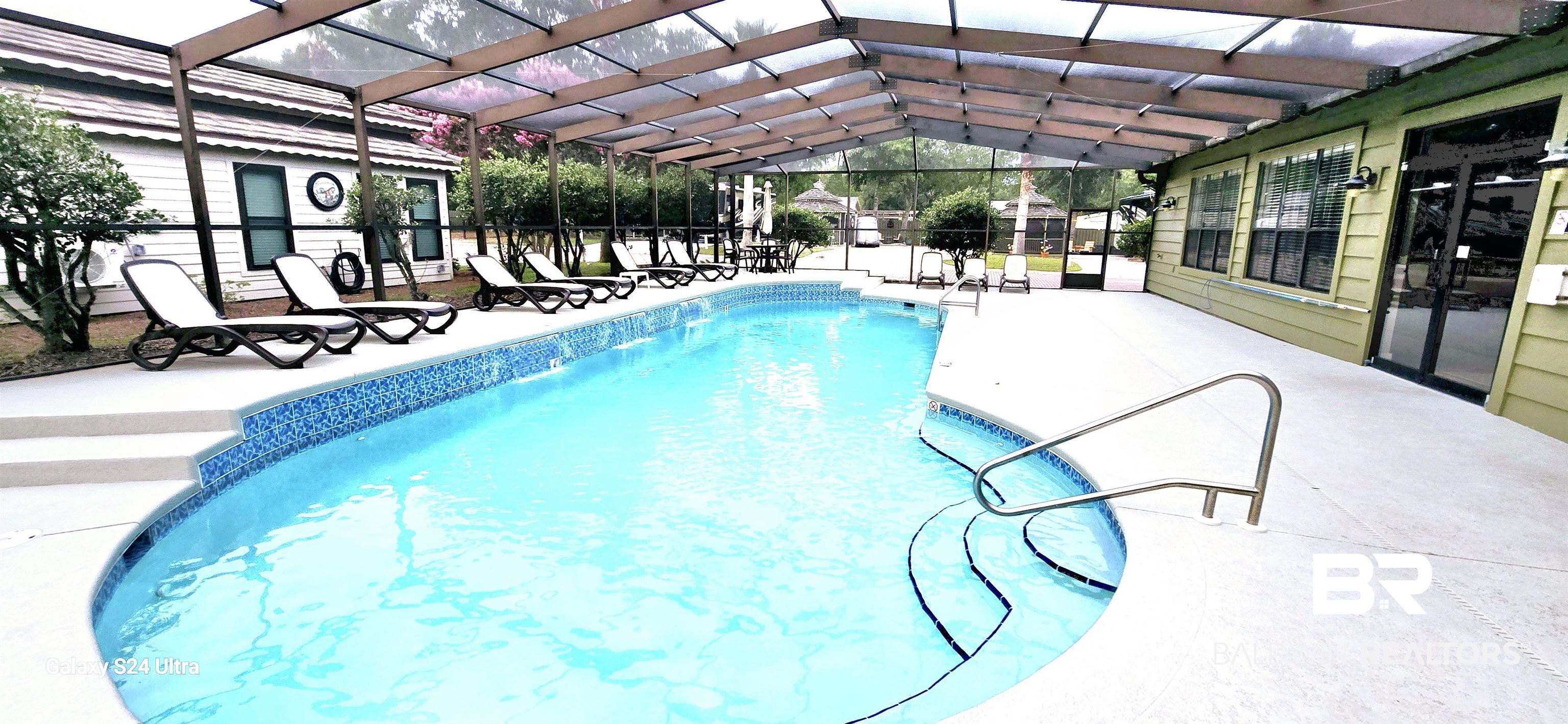 4650 Griffith Marina Road, Unit 6 Orange Beach, AL 36561 - Photo 21 of 27 Outdoor pool with a lanai and a patio area