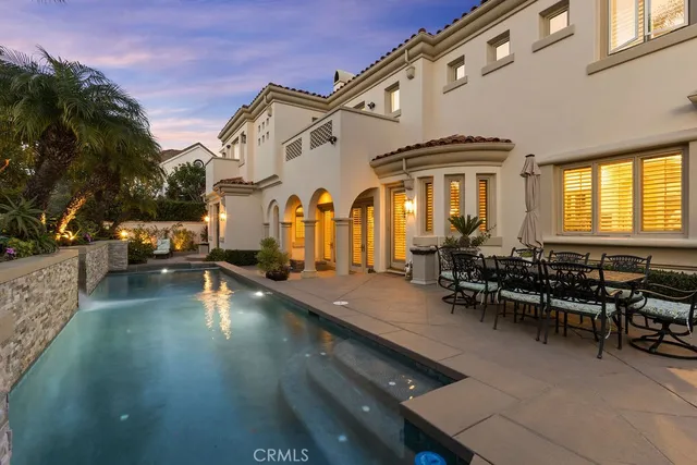 a backyard of a house with table and chairs