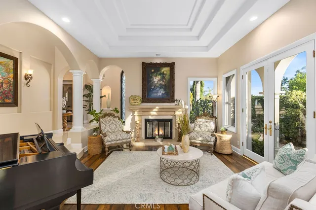 a living room with furniture fireplace and a large window