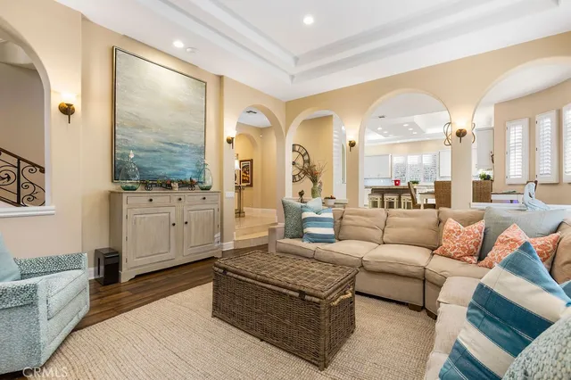 a living room with furniture wooden floor and white walls
