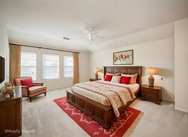 a bedroom with a bed couch and large window