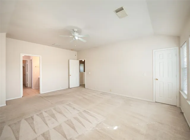 a view of an empty room with a kitchen