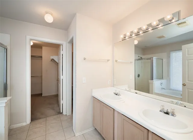 a en suite bathroom with a sink a mirror and a shower