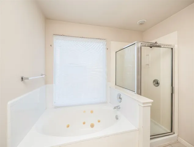 a bathroom with a bathtub and a shower