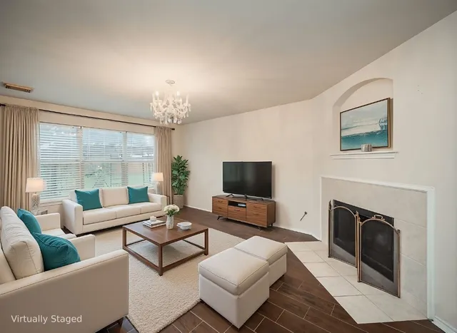 a living room with furniture a fireplace and a flat screen tv