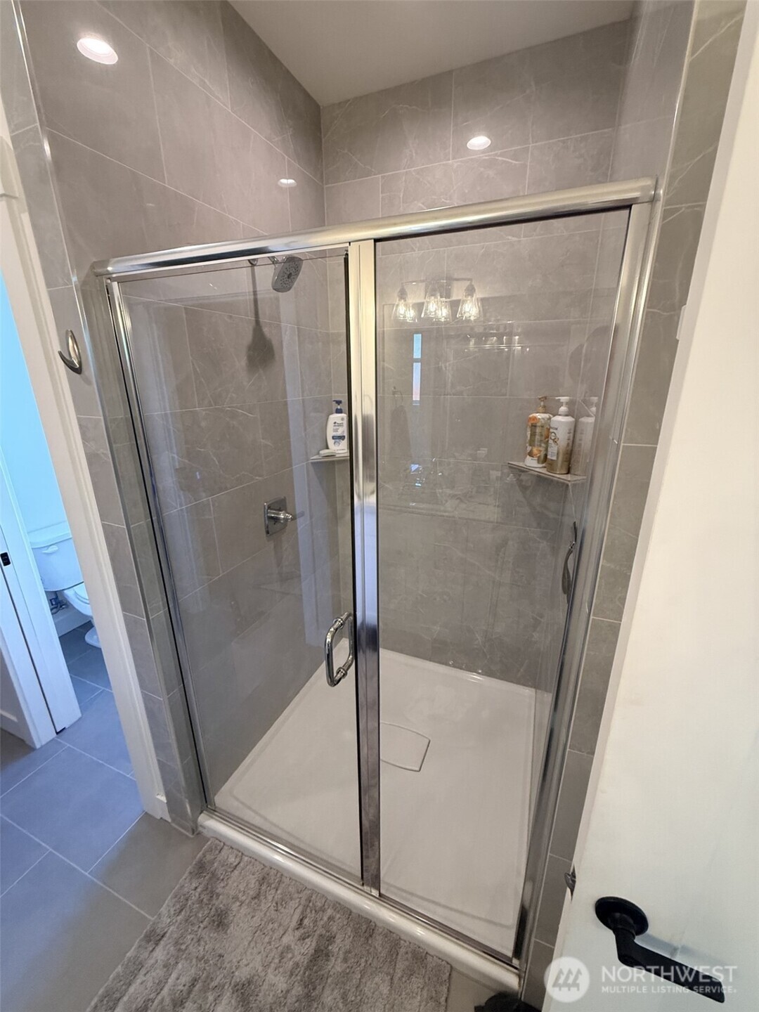 1200 Haystack Lane Everson, WA 98247 - Photo 13 of 16 a bathroom with a glass shower door