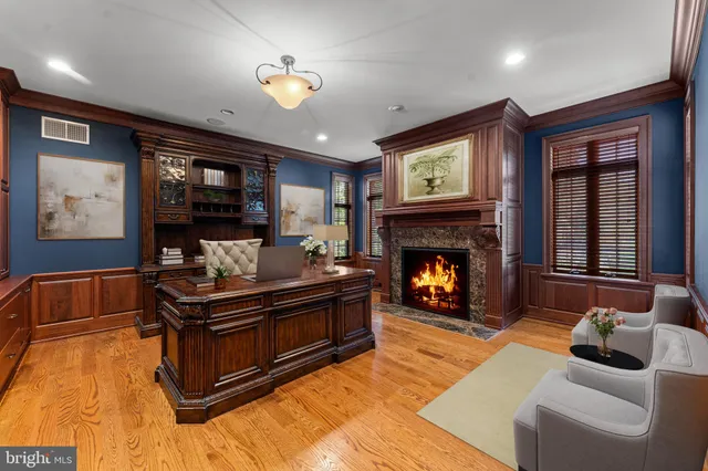a view of a livingroom with wooden floor and stairs