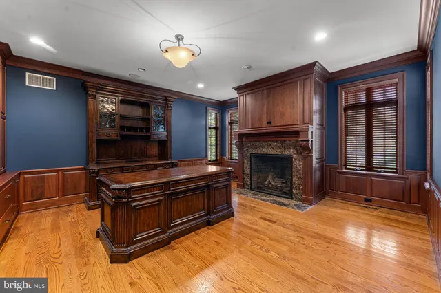 a kitchen with a stove a window and chairs