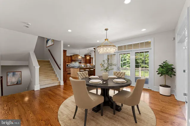 a kitchen with stainless steel appliances granite countertop a sink a stove and a wooden floors