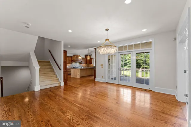 a kitchen with stainless steel appliances granite countertop a sink a stove and a wooden floors