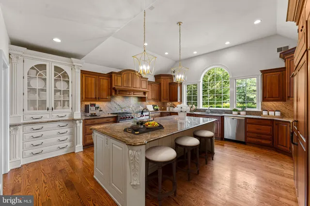 a bathroom with a toilet sink vanity and mirror